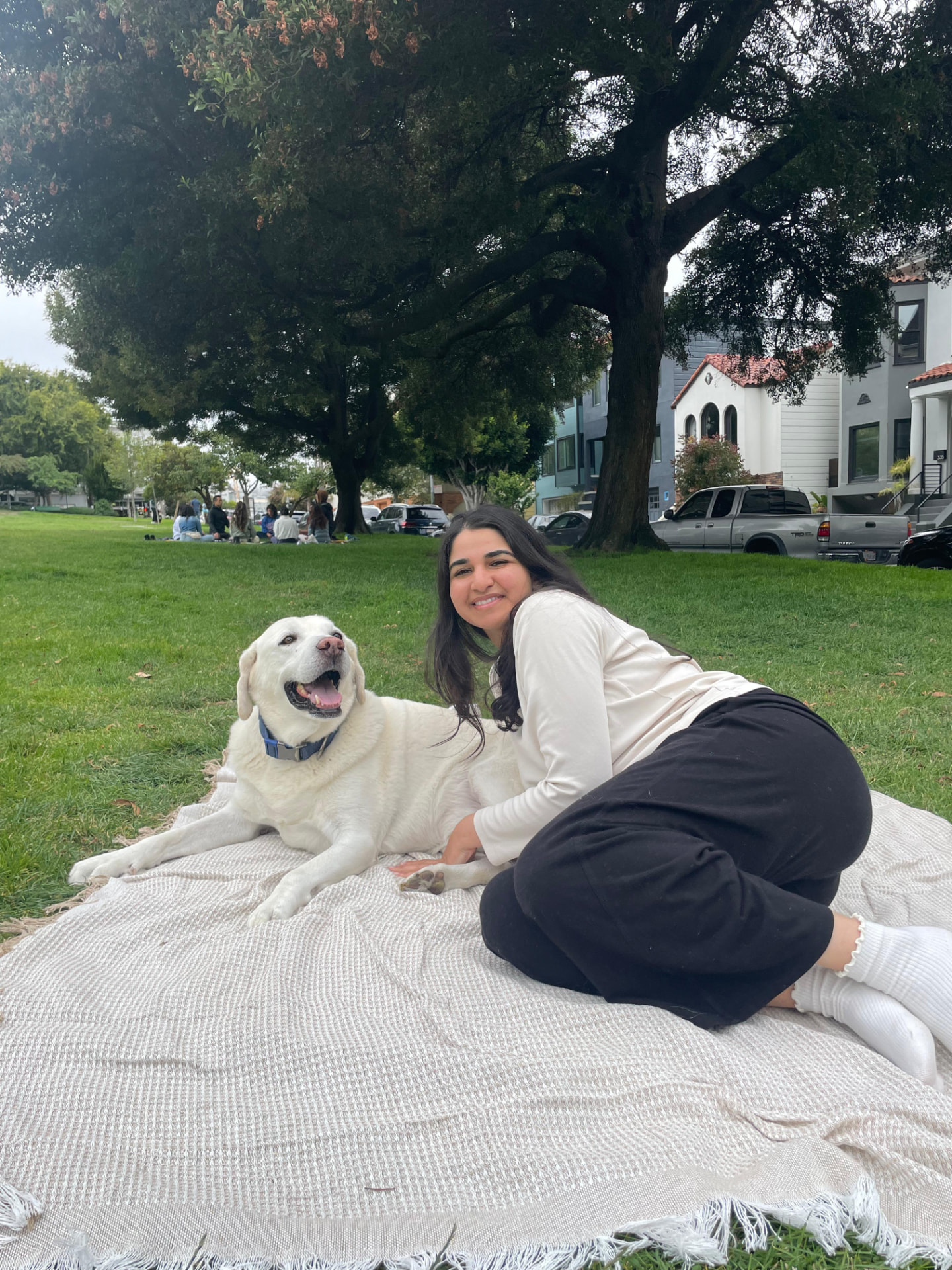 Sanjana with Firu, the neighbor's labrador, in the park